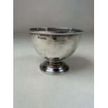 A planished sterling silver bowl on circular stepped foot by Colen Hewer Cheshire, Chester. 1903.
