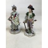 A pair of Stizendorf porcelain figurines of a gentleman and lady carrying flowers. H:24cm of