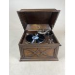 A His Masters Voice (HMV) oak gramophone with crank and spare needles. W:47cm x D:41cm x H:32cm