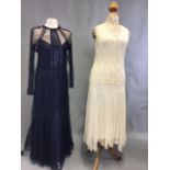 Two 1930s lace evening dresses. A navy lace, silk lined dress with mesh inserts together with a