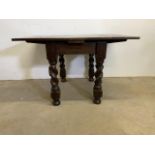 An oak drawer leaf table with turned legs Extended W:120cm x D:92cm x H:77cm