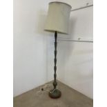 A metal floor lamp with wooden stand. H:150cm without shade.