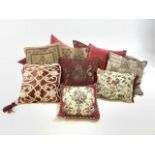 Twelve decorative cushions, to include velvet and embroidered covers in red and gold.