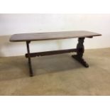 A early Ercol dark elm dinning table with stretcher bar and pegs. No stamp W:182cm x D:69cm x H: