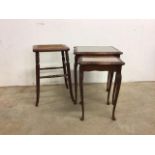 A cane seated four leg stool with turned legs and a nest of two tables with leather tops. Stool