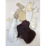 A collection of gloves and a pair of stockings including leather and crocheted gloves