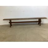 A Victorian pine school bench. W:210cm x D:25cm x H:40cm