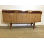 A mid century Formica sideboard - with three drawers above three cupboards. One with a drop