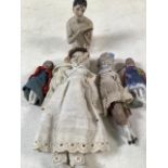 A collection of late 19th early 20th century dolls with ceramic elements.