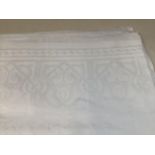 A large cotton damask table cloth with eight napkins ( not matching) W:228cm x L: 360cm approx.