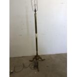 A gilt metal standard lamp with figural base