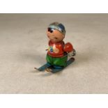 A 1960s tin plate wind up Chinese skier by Shanghai Kang Yuan Toy Factory. H:11cm