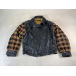 A 1980s Emporio Armani leather biker jacket with tartan arms and mustard coloured lining. Size L