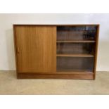 A Herbert E Gibbs teak veneered mid century bookcase with sliding doors one glazed. Two interior