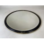 A mid century circular mirror with bevelled edge in black and gilt frame. W:72cm x H:72cm