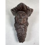 An antique carved oak wall sconce or bracket of a lady with grapes. W:17cm x D:17cm x H:25cm