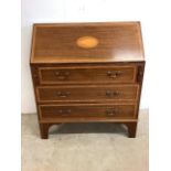 An inlaid drop front bureau with green leather writing slope and interior secretaire with three