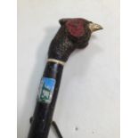 A wooden pheasant head cane with leather strap. Some signs of wormH:140cm