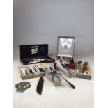 A collection of cutlery including silver plated items, a set of carvers, an AA badge and boxed
