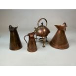 Three copper jugs , two with art nouveau decoration together with a copper and brass spirit kettle