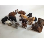 A collection of wooden and pottery elephants.