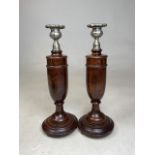 A pair of oak turned candlesticks with white metal candle holders.H:31cm