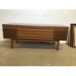 A mid century radiogram by Ferguson with accessories. W:128cm x D:46cm x H:52cm