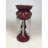 A hand decorated cranberry glass drop lustre with spare lustres W:18cm x H:36cm
