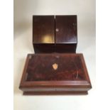 A mahogany letter holder and a canteen full of various knives.