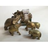 Brass elephants and a ceramic elephant.