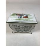 A ceramic Huntley and Palmer biscuit barrel Nursery Rhymes made by Royal Doulton in the form of a