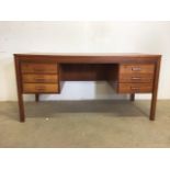 Heggen of Norway: a 1960's teak desk, with rectangular top with two banks of three drawers either