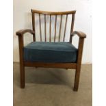 A mid century stick back hardwood arm chair. W:53cm x D:60cm x H:71cm