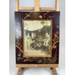 A late 19th early 20th century Japanese photograph with lacquer frame and gilt overlay. Numbered