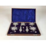 A complete sterling silver condiment set in velvet lined oak case by Henry Matthews, Birmingham 1909