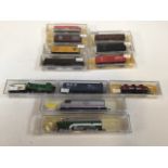 A collection of N gauge engines Amtrak and Burlington Northern with four rolling stocks also with