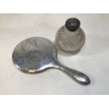 A sterling silver planished hand mirror,Birmingham 1907 together with a sterling silver topped cut