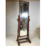A pine cheval mirror, with bevelled edge and double stretch bars to base.