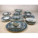 A large collection of mixed blue and white china including tureens, platters and plates