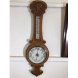 An oak barometer. H:90cm