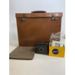 A square leather case marked Richards Maker Bath also with a brownie camera old film and an empty