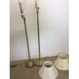 Two adjustable brass coloured standard lamps and shades. Tallest H:135cm