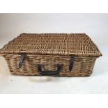 A vintage wicker hamper with a ceramic setting for four together with picnic blanket and map W: