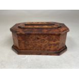 A birds eye maple tea caddy of octagonal form with offset plinth and three tier lid. W:22cm x D: