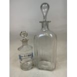 An etched glass decanter with etched grape vines, laurel leaves and feathered birds, with stopper