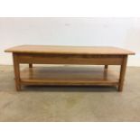 An Ercol Windsor supper table in solid ash, lift up top, lower shelf and interior storage drawer.