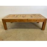 A heavy pine coffee table with tiled top.W:123cm x D:60cm x H:37cm