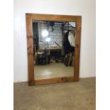A large rustic pine framed mirror.W:94cm x H:120cm
