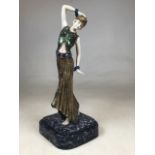 A reproduction Art Deco figurine on faux marble plinth. H:39cm