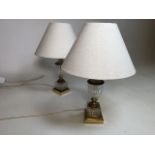A pair of glass and brass table lamps with linen look shades